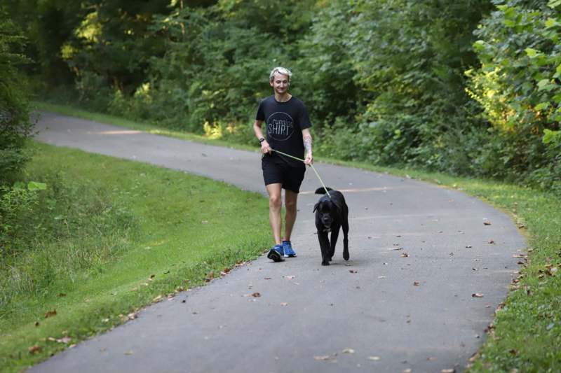 a man walking a dog on a path