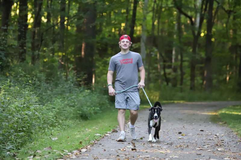 a man walking a dog on a path