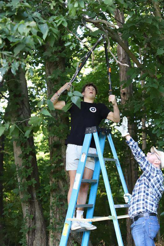 a man on a ladder holding a ladder with a man on it
