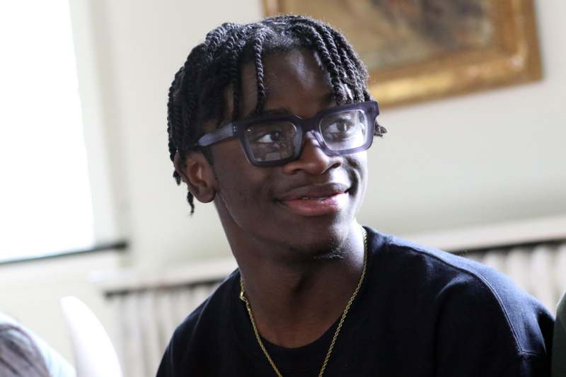 a man wearing glasses and a black shirt
