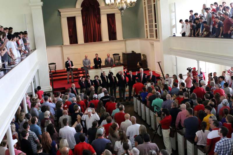 a group of people standing on a stage in front of a crowd