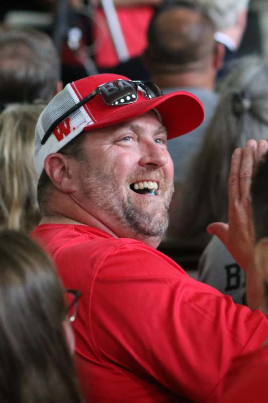 a man in a red shirt and hat