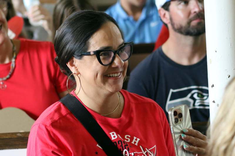 a woman in glasses smiling
