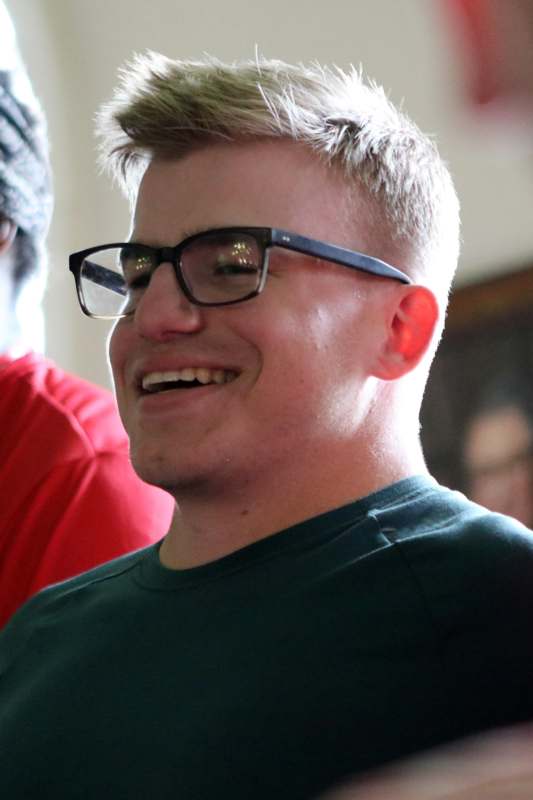 a man wearing glasses smiling