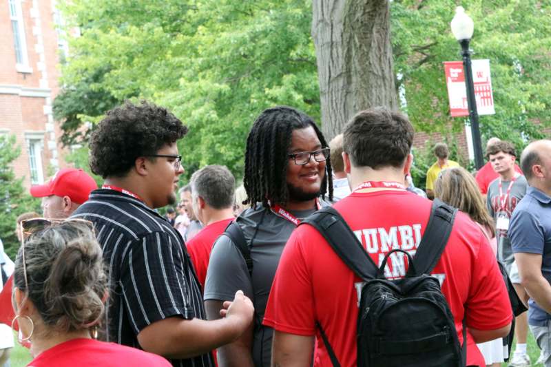 a group of people in red shirts