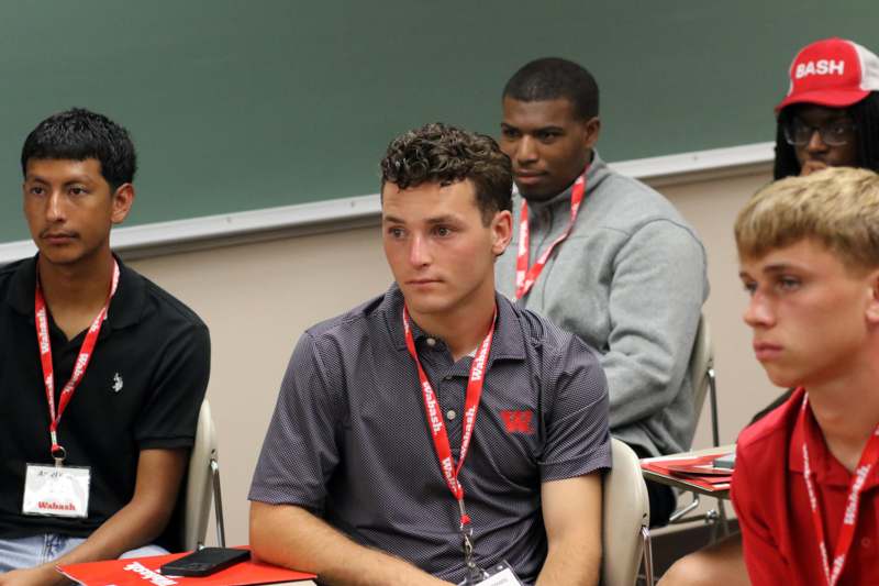 a group of men sitting in a classroom