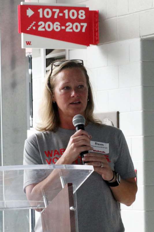 a woman speaking into a microphone