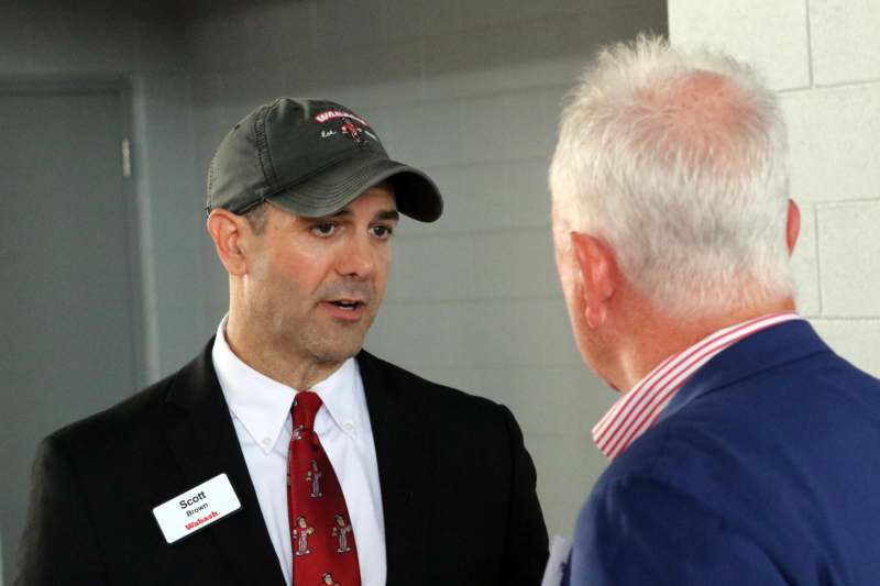 a man in a suit talking to another man