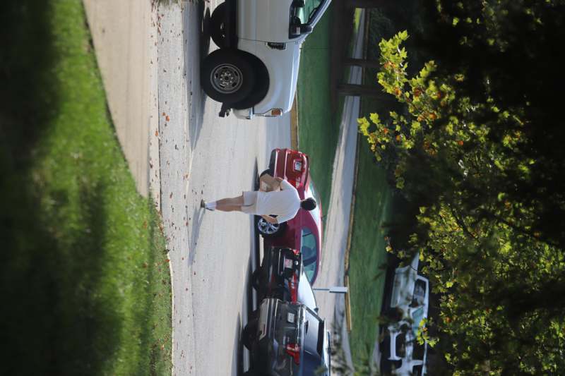 a man walking in a parking lot