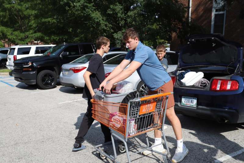 a group of people pushing a shopping cart