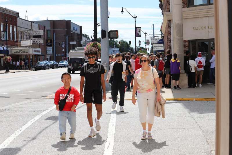 a group of people walking on a street