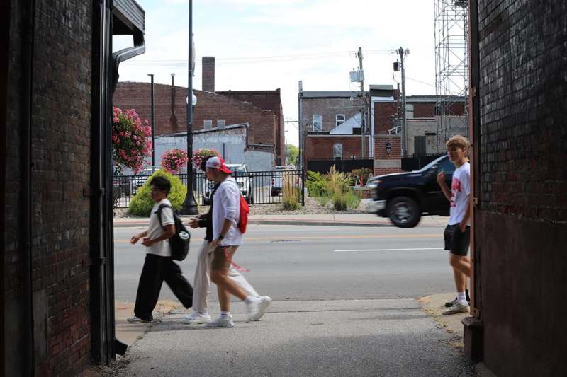 a group of people walking on a street