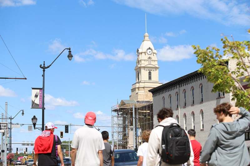 a group of people walking on a street
