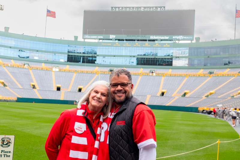 a man and woman standing in a stadium