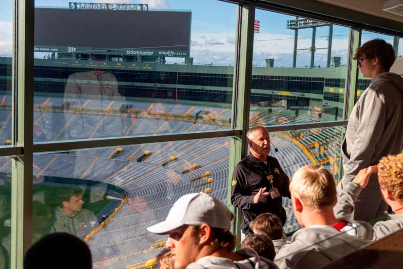 a man speaking to a group of people in a stadium