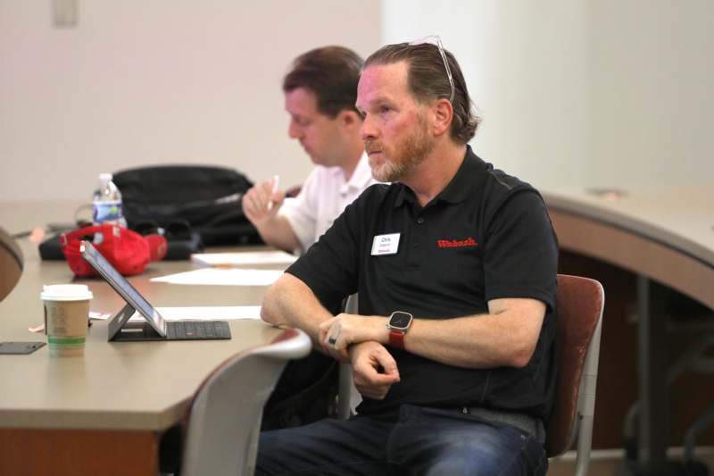 a man sitting at a table with his arms crossed
