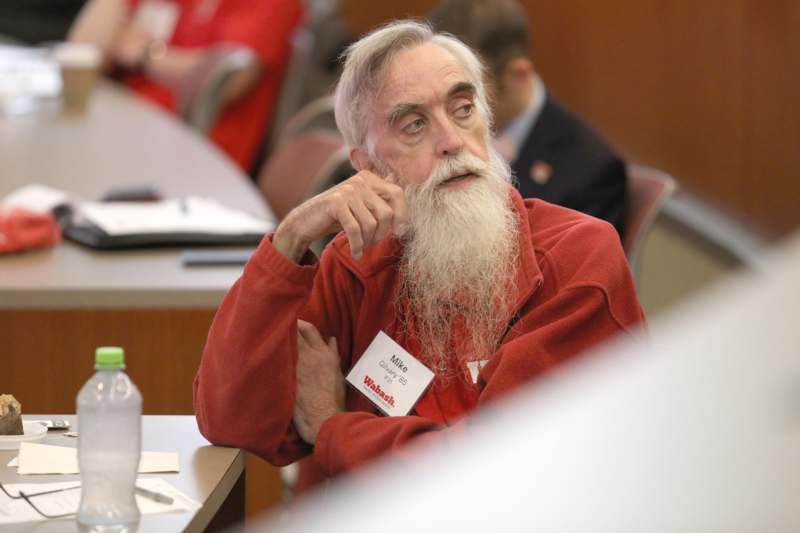 a man with a long beard sitting at a table