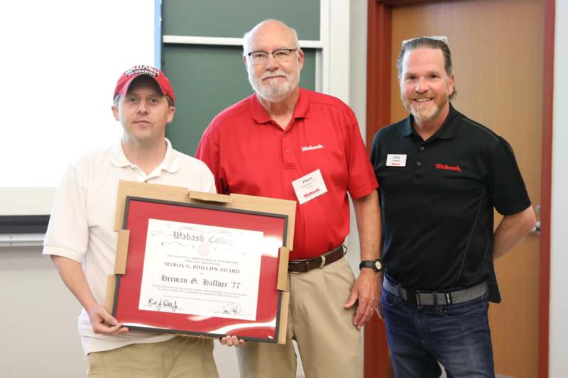 a group of men holding a certificate