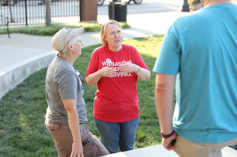 a group of women talking in a park