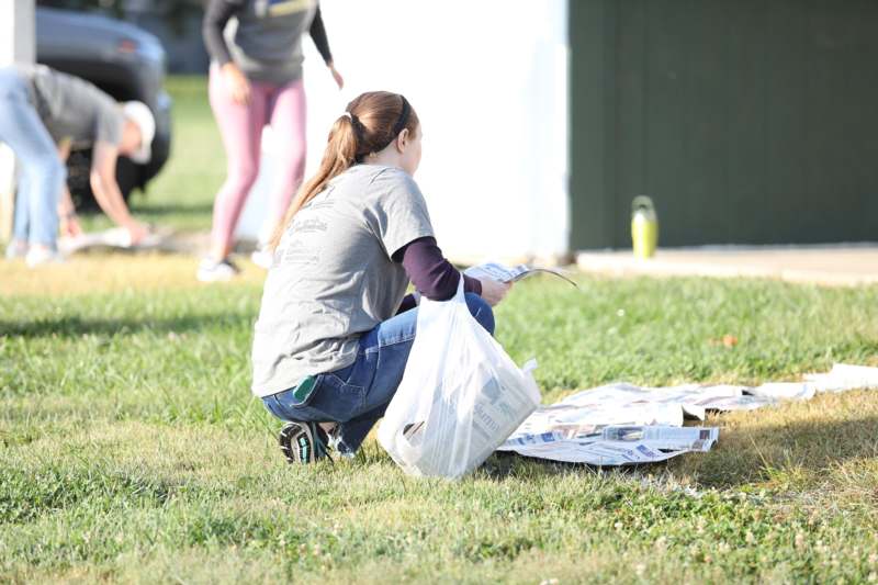a woman kneeling on the grass