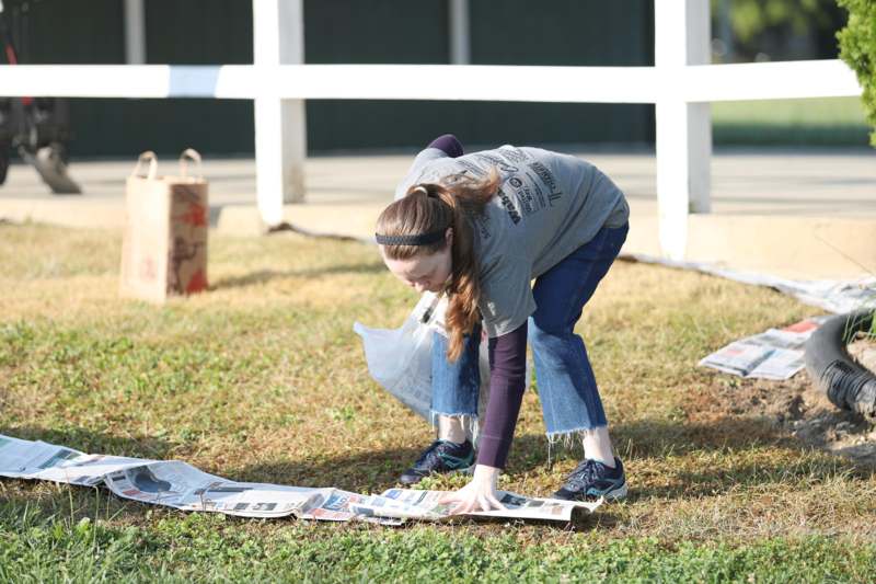 a girl bending over on newspaper