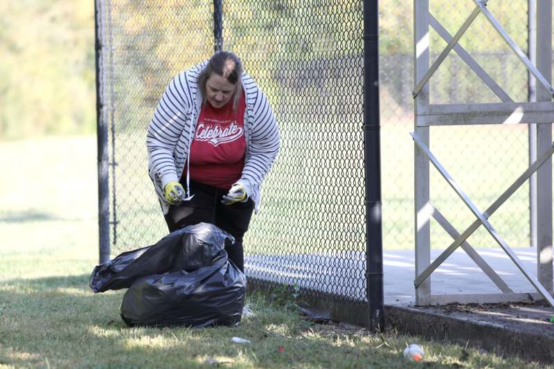 a woman picking up trash