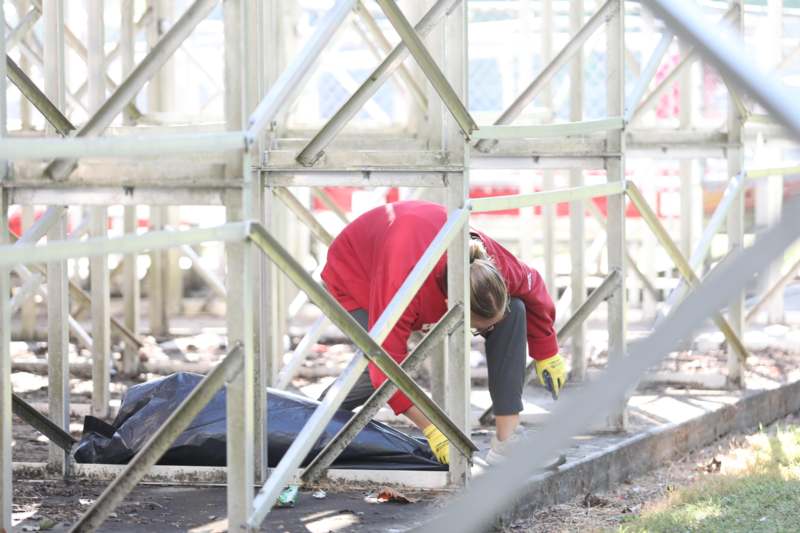 a woman in a red shirt bending over