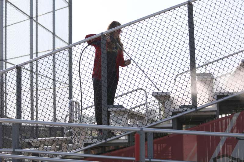 a woman holding a hose
