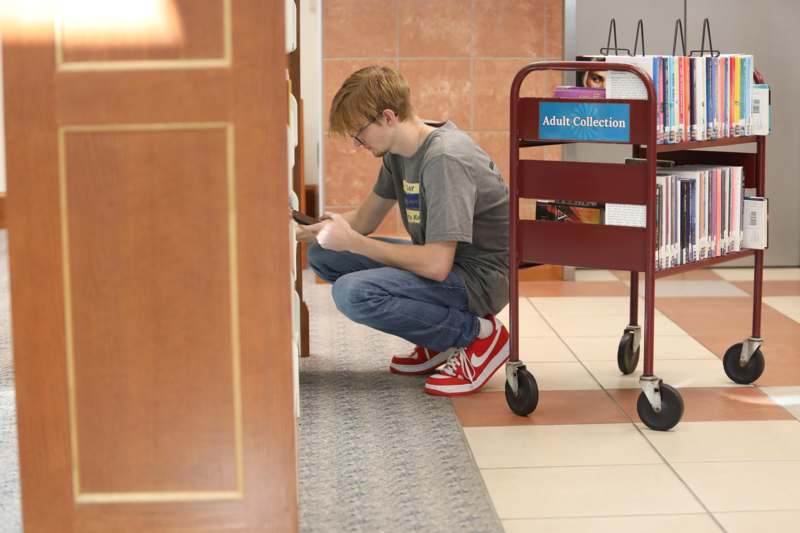 a man kneeling down in a library