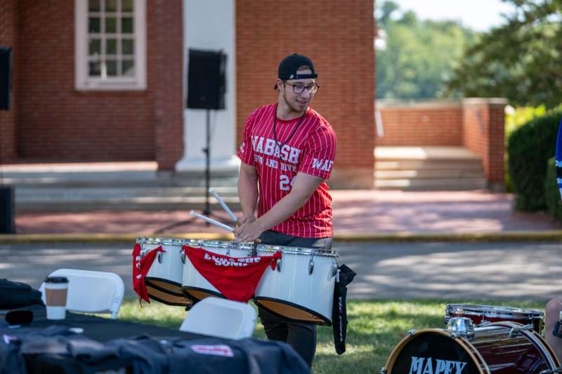 a man playing drums outside