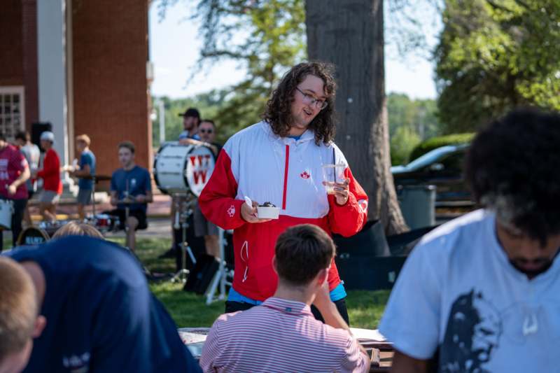 a man holding a cup of ice cream