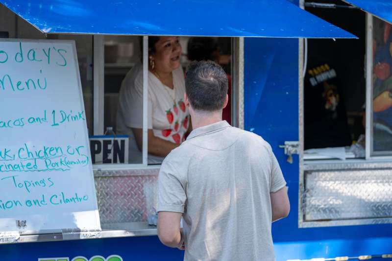 a man standing in front of a food truck