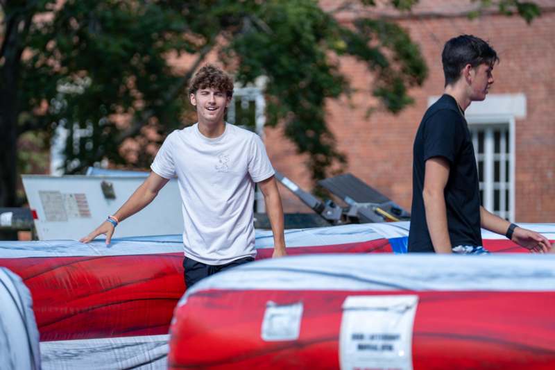 a man standing next to a red and white inflatable raft