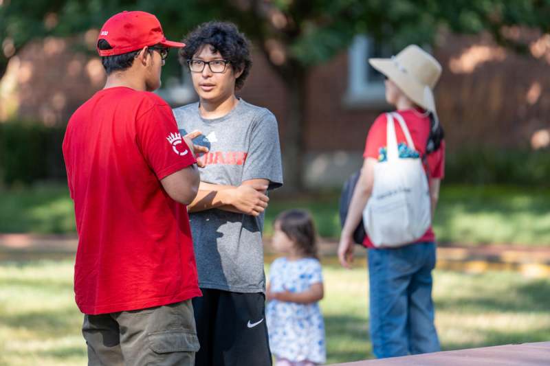 a group of people talking outside