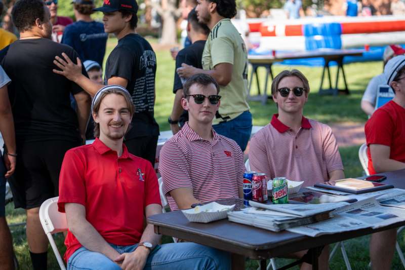 a group of men sitting at a table