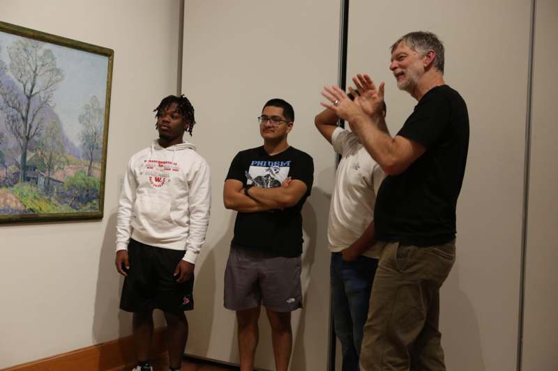 a group of men standing in a room