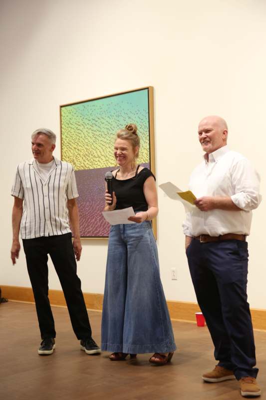 a woman holding a microphone and standing next to a man