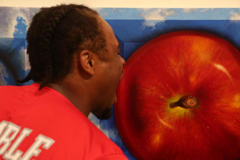 a man looking at a painting