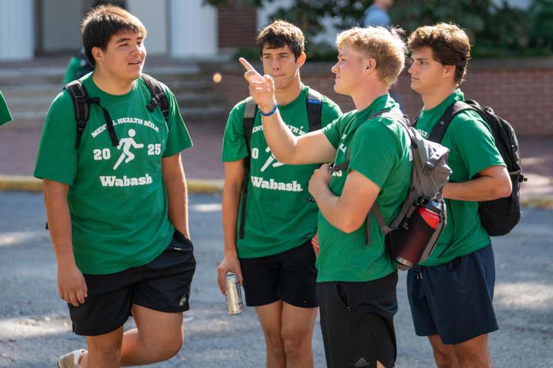 a group of boys wearing green shirts