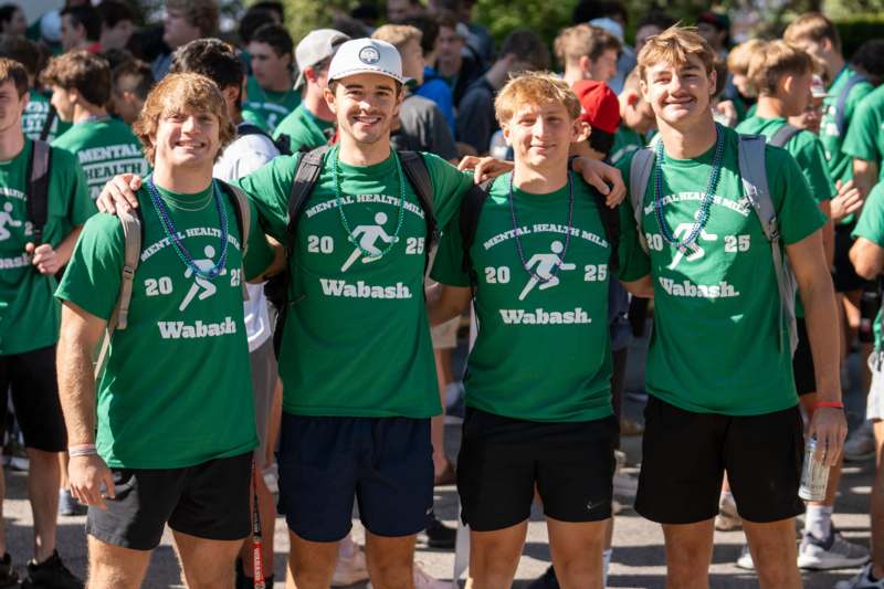 a group of men wearing green shirts