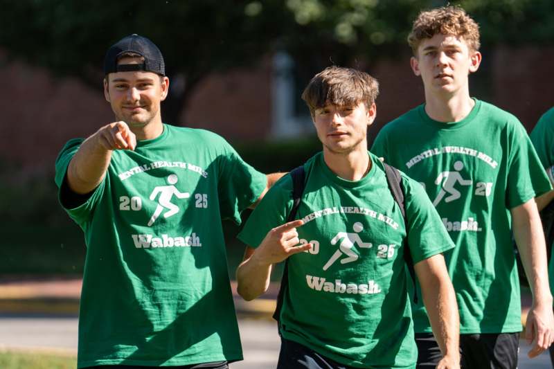 a group of men in green shirts