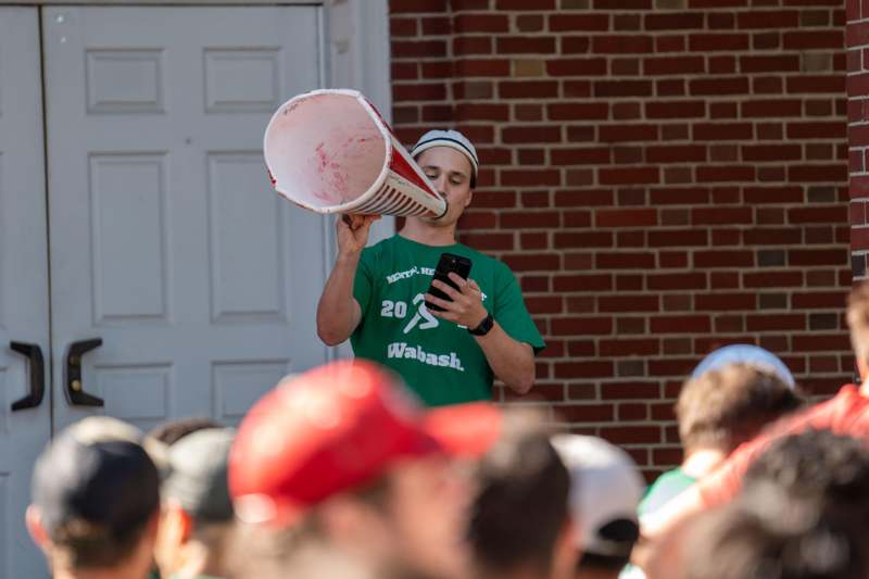 a man holding a phone and a megaphone
