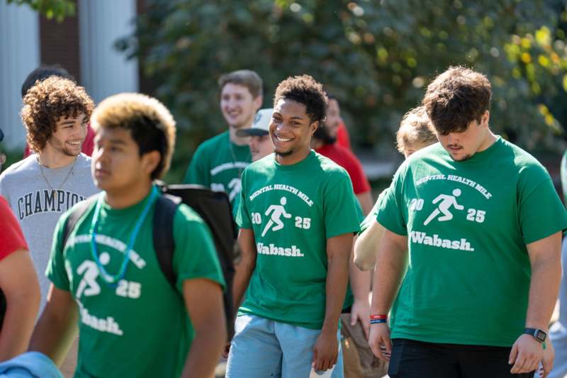 a group of people wearing green shirts