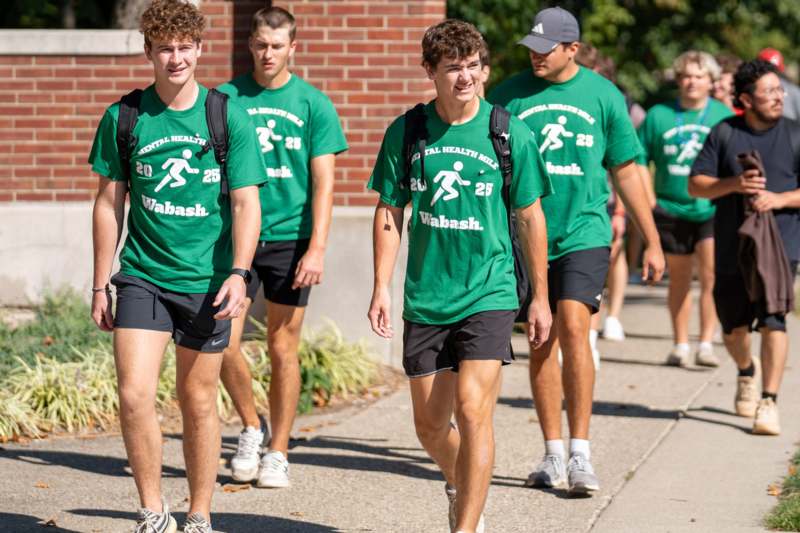 a group of men wearing green shirts