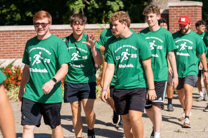 a group of men in green shirts