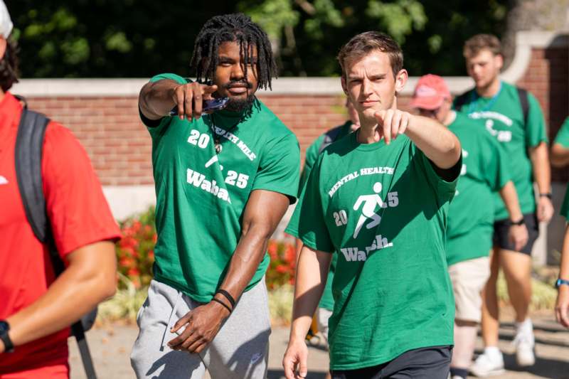 a group of men in green shirts