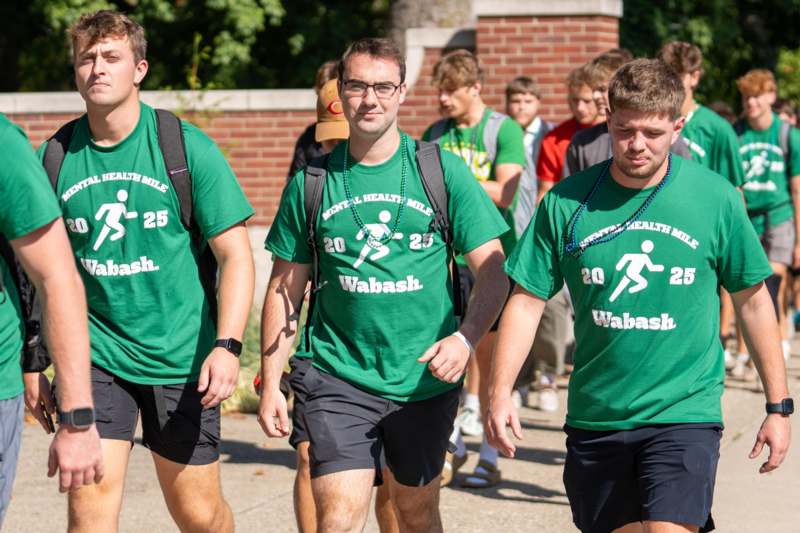 a group of men wearing green shirts