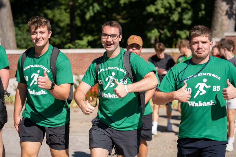 a group of men wearing green shirts