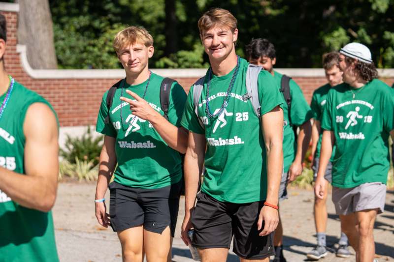 a group of young men wearing green shirts