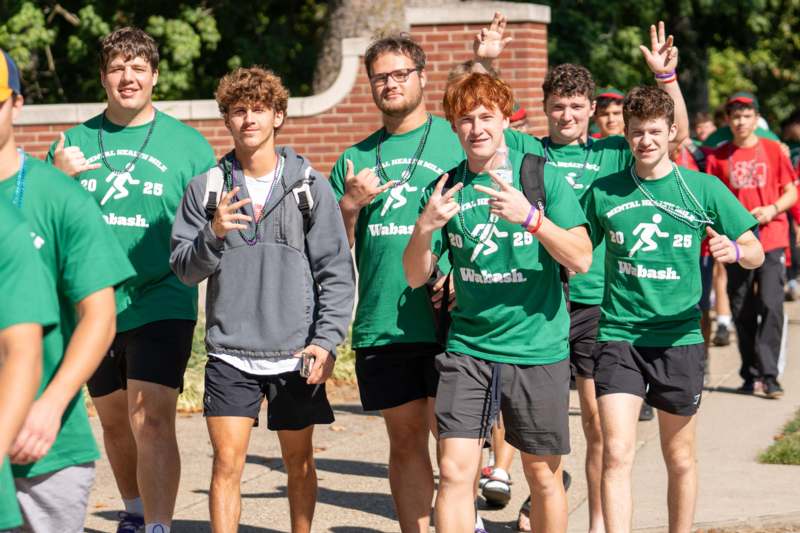 a group of men in green shirts